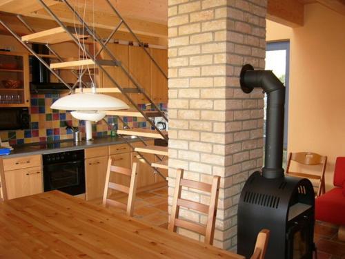 a kitchen and dining room with a wood stove at Holiday home Belvedere in Alt Schwerin