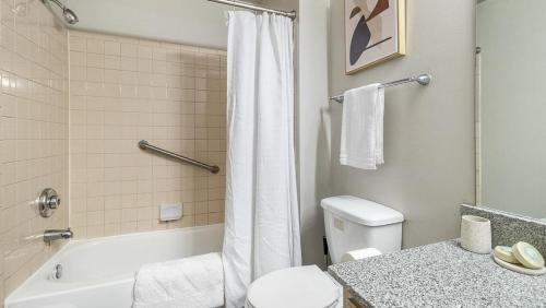a bathroom with a white toilet and a shower at Landing Modern Apartment with Amazing Amenities (ID9997X84) in Birmingham