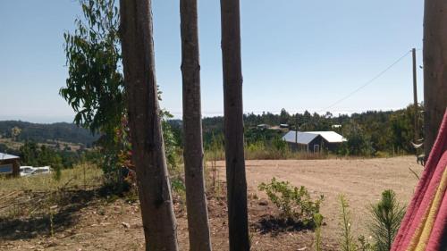 a view of a dirt field through a fence at Cabaña Familiar La Polcura in Navidad