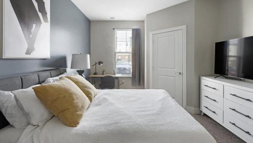 a bedroom with a bed with a television and a dresser at Landing Modern Apartment with Amazing Amenities (ID8145X4) in Toledo