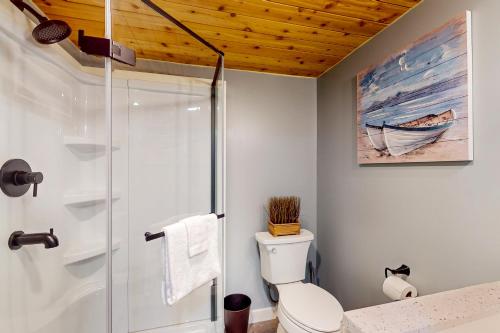 a bathroom with a shower stall and a toilet at The Gull's Nest at Isle of Wight in Ocean City
