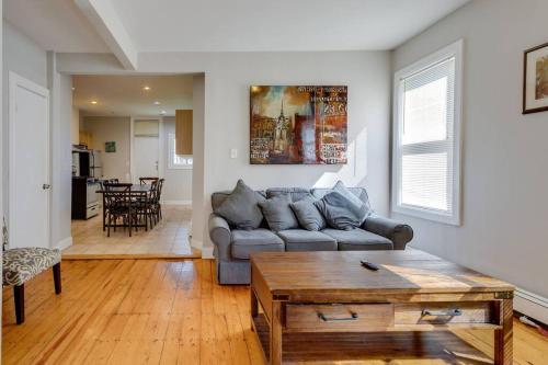 a living room with a couch and a table at NEW! Boston Condo Near MBTA, 3 Mi to Fenway! (U2) in Boston