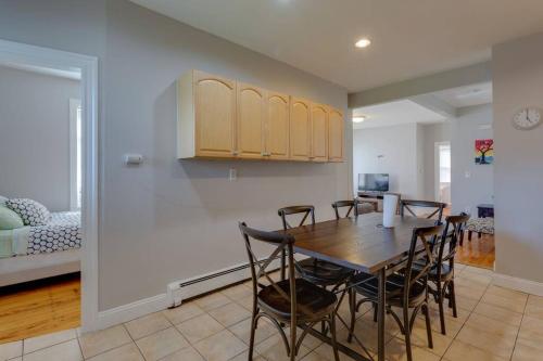 a kitchen and dining room with a table and chairs at NEW! Boston Condo Near MBTA, 3 Mi to Fenway! (U2) in Boston
