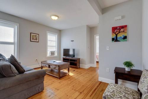 a living room with a couch and a table at NEW! Boston Condo Near MBTA, 3 Mi to Fenway! (U2) in Boston