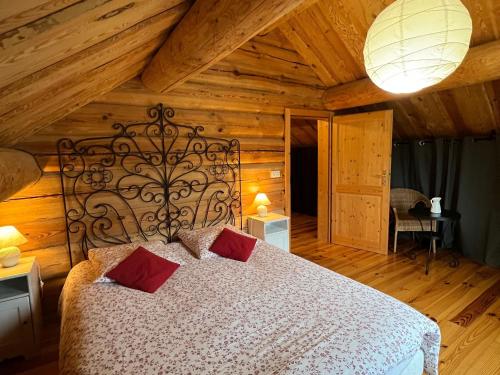 a bedroom with a large bed with red pillows at Gîte Anould, 4 pièces, 6 personnes - FR-1-589-49 in Anould