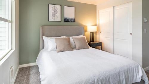 a bedroom with a large white bed with two pillows at Landing Modern Apartment with Amazing Amenities (ID9692X16) in Everett