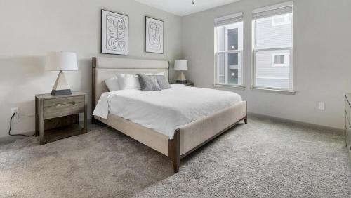 a white bedroom with a large bed and a window at Landing Modern Apartment with Amazing Amenities (ID8935X21) in Middleburg
