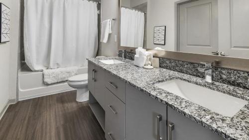 a white bathroom with a sink and a toilet at Landing Modern Apartment with Amazing Amenities (ID8935X21) in Middleburg