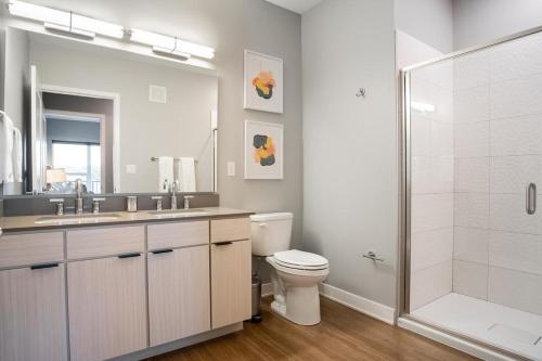 a bathroom with a shower and a toilet and a sink at Landing Modern Apartment with Amazing Amenities (ID5034X58) in Tower Grove