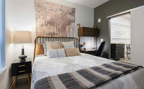 a bedroom with a large bed with a map on the wall at Landing Modern Apartment with Amazing Amenities (ID1228X660) in Cambridge