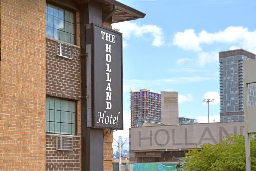 a hotel sign on the side of a brick building at Holland Hotel Free Parking Jersey City in Jersey City