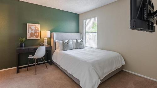 a bedroom with a bed and a desk and a window at Landing Modern Apartment with Amazing Amenities (ID9665X12) in Seabrook