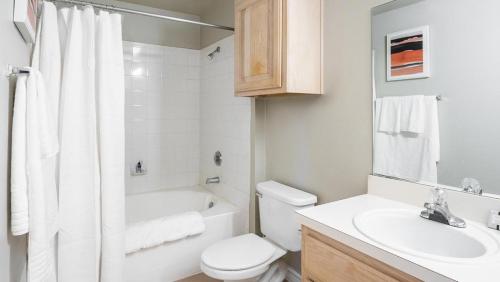 a white bathroom with a toilet and a sink at Landing Modern Apartment with Amazing Amenities (ID8628X77) in Tulsa