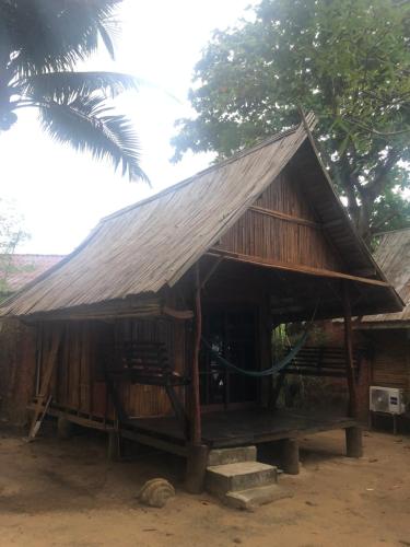a small hut with a roof on top of it at Sanctuary Lanta in Ko Lanta
