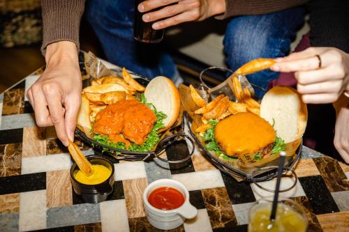 a group of people sitting at a table with food at Moxy Osaka Umeda in Osaka