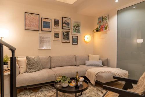 a living room with a couch and a table at Loft on Collins/Swanston - 2 storey - 2 bed 2 bath in Melbourne