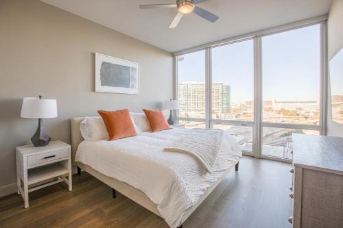 a bedroom with a bed and a large window at Landing Modern Apartment with Amazing Amenities (ID512) in Dallas