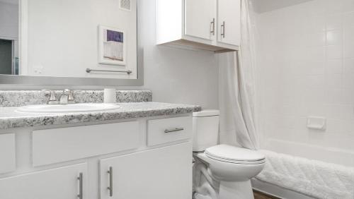 a white bathroom with a toilet and a sink at Landing Modern Apartment with Amazing Amenities (ID1401X027) in Tucson