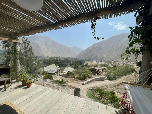 a view from the deck of a house with mountains in the background at Las Cabañas de Tarii in Cieneguilla