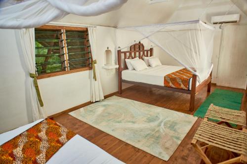 a bedroom with a bed and a window at Lions' Luxury Eco Resort & Spa in Malindi