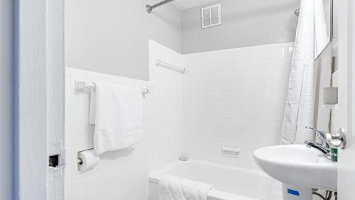 a white bathroom with a sink and a toilet at Landing Modern Apartment with Amazing Amenities (ID9104X34) in Alexandria