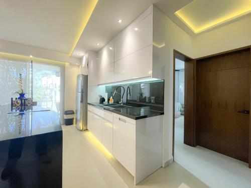 a kitchen with white cabinets and a sink at The Best of Marbella in Puerto Vallarta