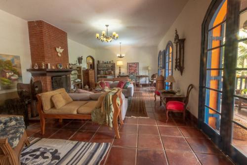 a living room with a couch and a fireplace at Via Antiga Granja Viana in Cotia