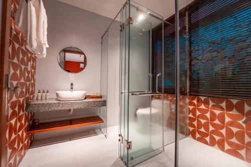 a bathroom with a sink and a glass shower at TRUONG PHU HOUSE - HOTEL & APARTMENT in Hue