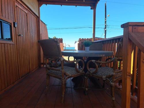 a patio with a table and two chairs on a deck at Sunset Trailer Park RV #1 in El Suazal