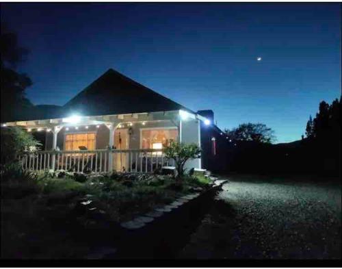 a house lit up at night with lights at Private Guest Cozy Room w/Full Bathroom in Lake Isabella