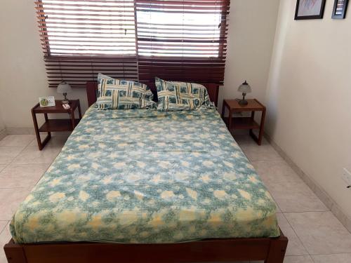 a bed in a bedroom with two night tables at Quien lo vive es quien lo goza in Barranquilla