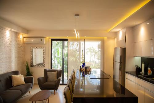 a kitchen and living room with a glass table in a room at The Best of Marbella in Puerto Vallarta