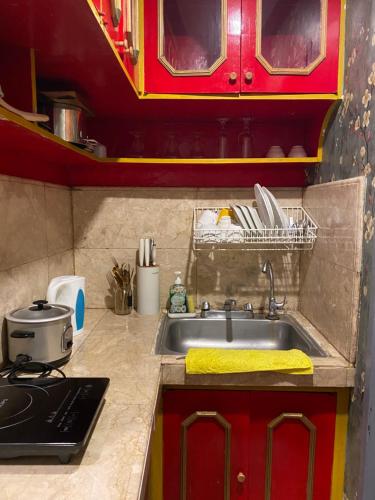 a kitchen with a sink and a stove at Casa Valle Verde in Baguio