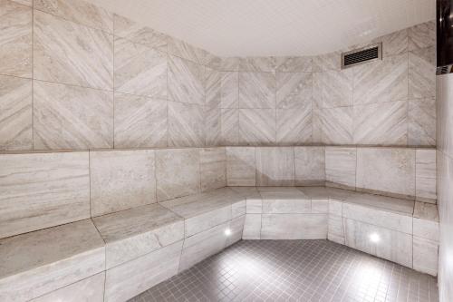 an empty room with a tiled wall with aitating at Hilton Grand Vacations Club Whistler in Whistler