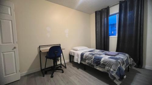a bedroom with a bed and a desk and a window at Private Rooms in a 3 Bedroom Guest House Close to Londonderry Mall 1 Person per Room No Couples For Men Only in Edmonton