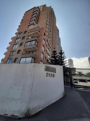 a tall building with a sign in front of it at VSM propiedades in Iquique