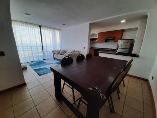 a kitchen and living room with a table and a couch at VSM propiedades in Iquique