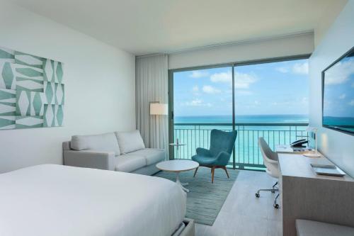 a hotel room with a bed and a desk at La Concha Renaissance San Juan Resort in San Juan