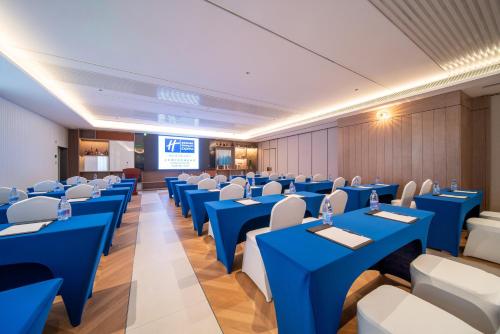 a conference room with blue tables and white chairs at Holiday Inn Express Shanghai Pujiang Lianhang Road by IHG in Shanghai