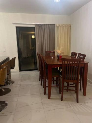 a dining room with a wooden table and chairs at Casa Ros in Bucerías