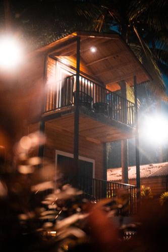 a table in front of a house at night at Tranquill Riverside Luxury Cottages With Bathtub, Candolim in Candolim
