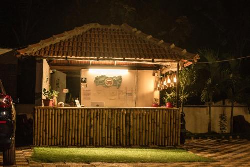 a small building with a sign on it at night at Tranquill Riverside Luxury Cottages With Bathtub, Candolim in Candolim