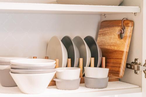 a shelf with plates and utensils in a kitchen at Staylim - Seoul Botanic Park, Airport in Seoul