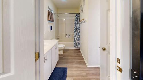 a bathroom with a white tub and a toilet at Water Haus in Fourth Crossing