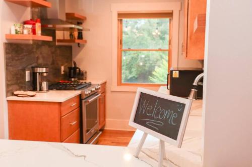 a kitchen with a chalkboard sign in a kitchen at Quiet, Immaculate Denver Home Relax or Work Near Dining & Attractions! in Denver