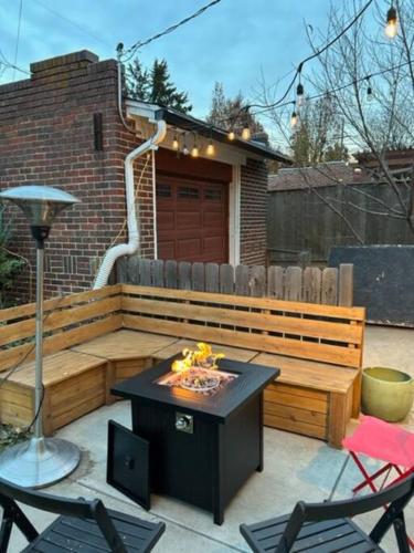 a patio with a table and chairs and a fire pit at Quiet, Immaculate Denver Home Relax or Work Near Dining & Attractions! in Denver