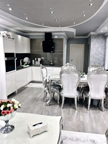 a kitchen with a table and chairs in a room at Su Apartments in Struga