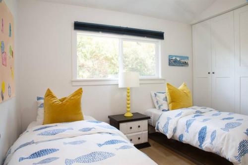 1 dormitorio con 2 camas y ventana en Geometric Loft: renovated, hip, pets, pool/spa, en Solana Beach