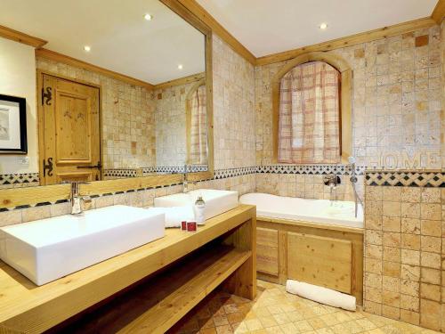 a bathroom with two sinks and two mirrors at Chalet Courchevel 1850, 5 pièces, 8 personnes - FR-1-575-218 in Courchevel