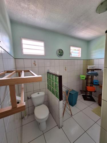 a bathroom with a toilet and a sink at Villa bois rose in Petit-Bourg